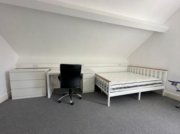 A bright and tidy double bedroom featuring a wh...