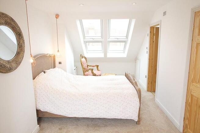 This charming double bedroom features ample nat...