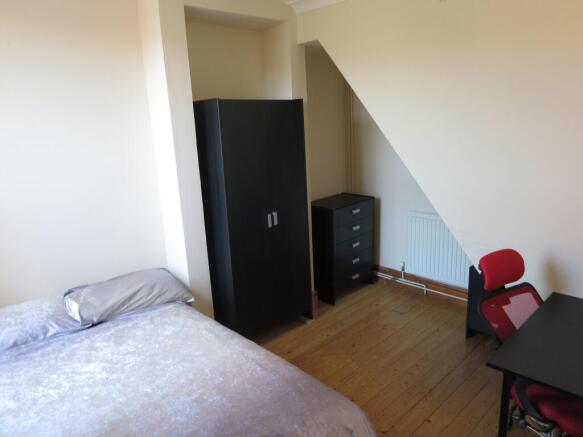 Cozy double bedroom featuring a comfortable bed...