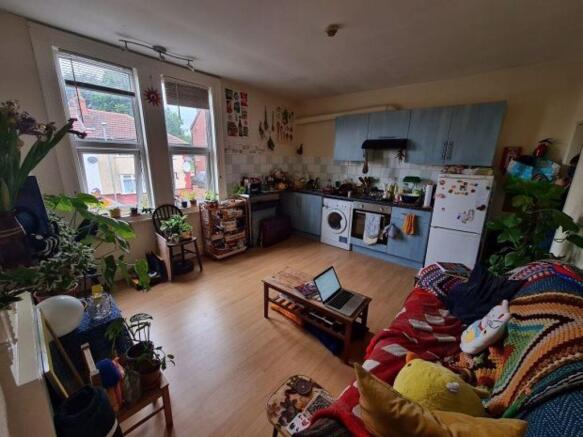 Bright, homely living room with large windows, ...