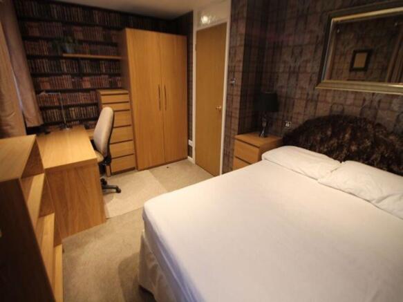 Bright, neatly presented bedroom with a comfort...