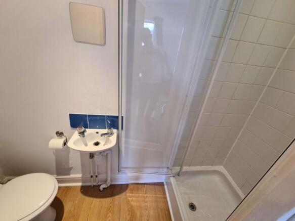Compact, well-maintained bathroom with a corner...