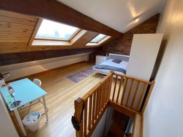 Bright, characterful loft bedroom with angled w...