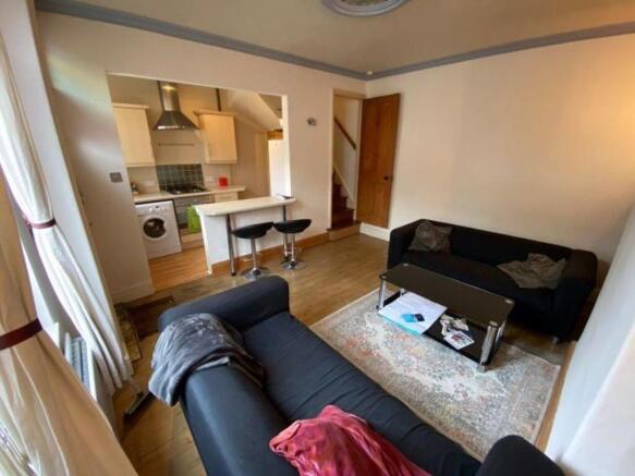 Bright open-plan living area with two comfortab...