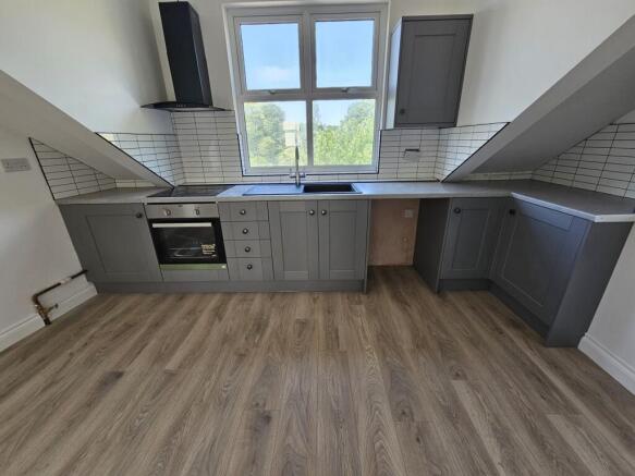 Modern kitchen with grey shaker-style cabinets,...