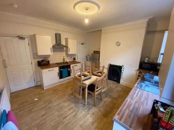 Bright open-plan kitchen with modern units, int...