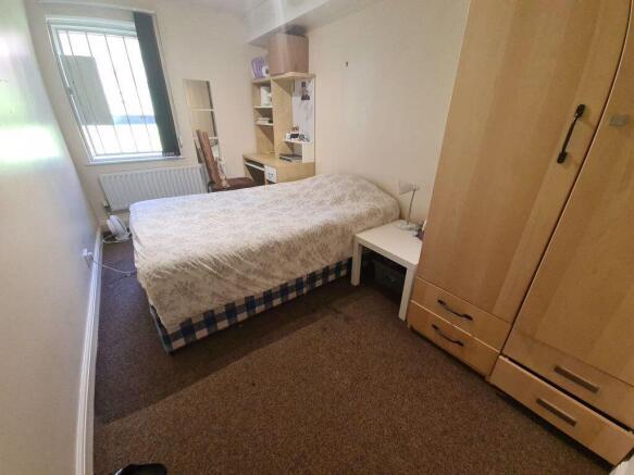 Bright, simply furnished double bedroom with a ...