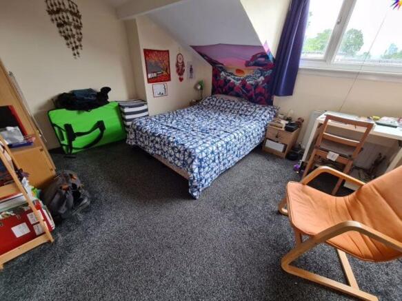 Bright, cozy bedroom with a comfortable double ...