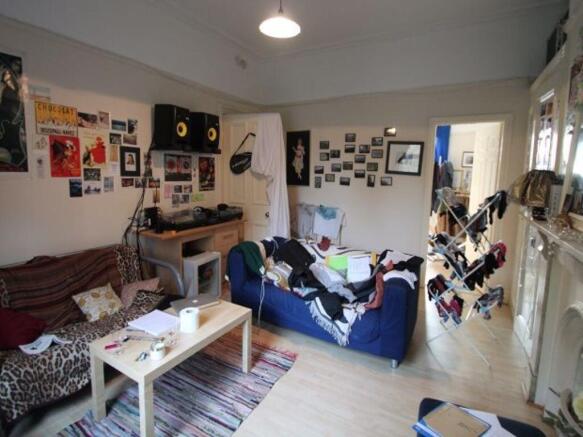 Bright, relaxed communal living room with comfy...