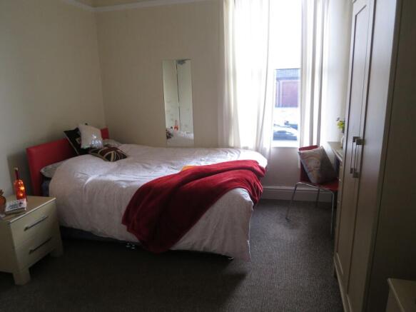 A bright, well-maintained bedroom featuring a l...