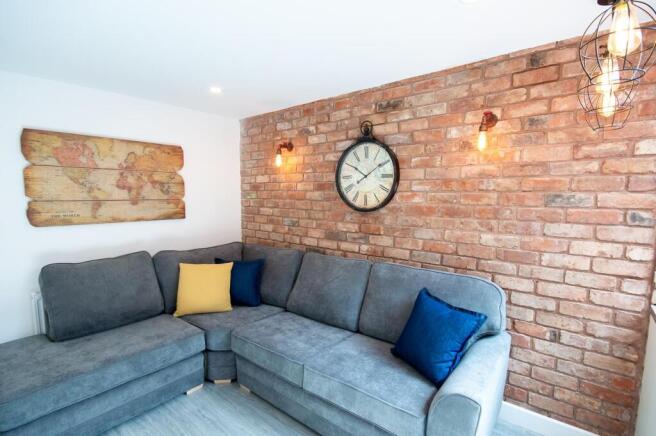A stylish living room featuring a spacious grey...