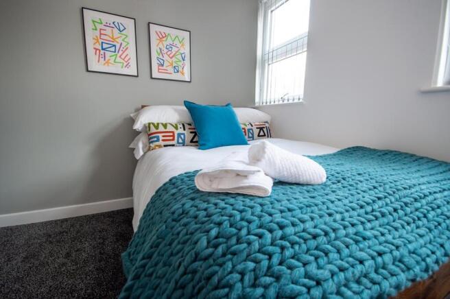 A bright and modern double bedroom featuring a ...