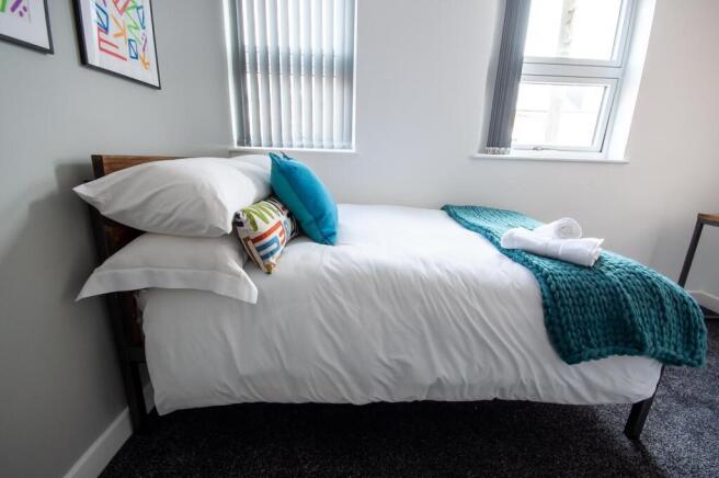 A bright and welcoming double bedroom featuring...