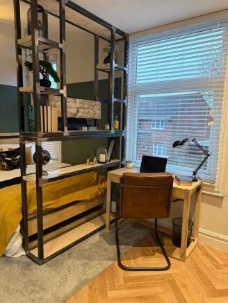 A well-lit, cozy single bedroom featuring a com...