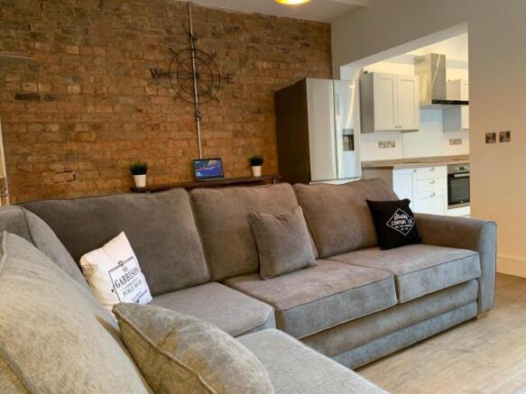 A spacious, well-maintained living room with a ...