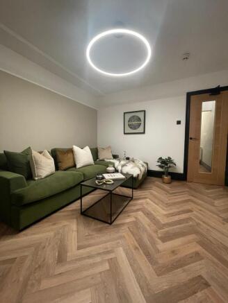 Modern and stylish living room featuring a comf...