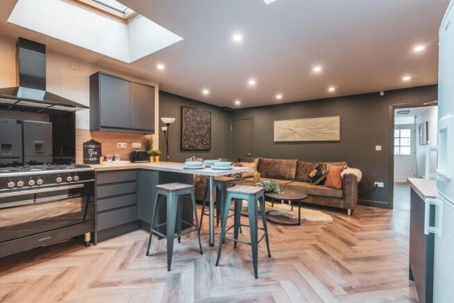 Spacious and modern living room featuring a com...