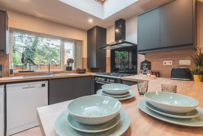 Modern and well-lit kitchen with large window, ...