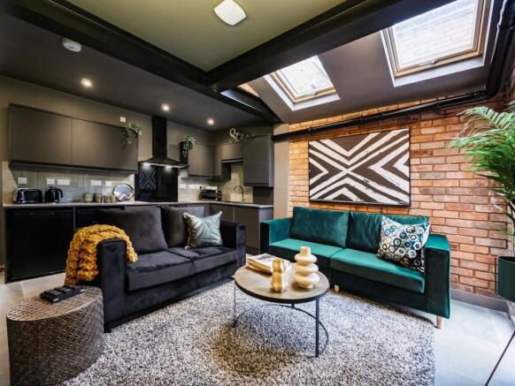 Modern, stylish living room featuring a cozy bl...