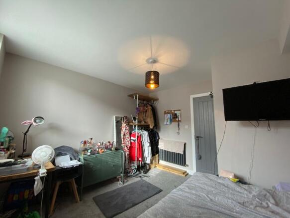 A cozy living room with various personal items,...