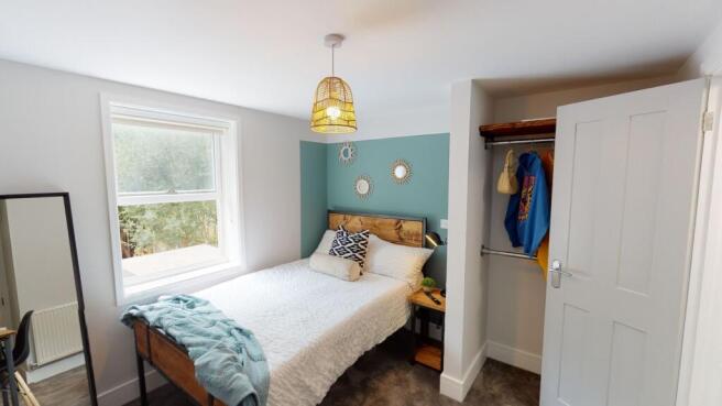 Bright and welcoming bedroom featuring a large ...