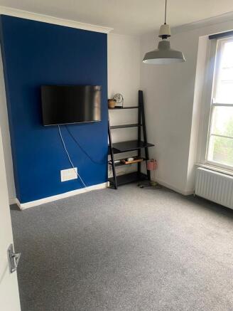 Bright and tidy living room featuring a vibrant...