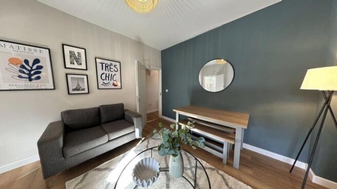 A bright, stylish living room featuring a comfo...