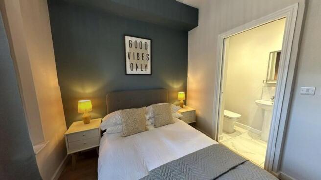 A cozy, well-maintained bedroom featuring a com...