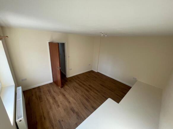 Bright and spacious living room with wooden flo...