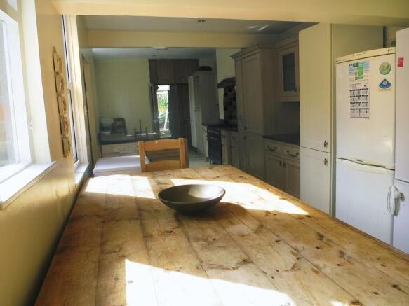 Bright and welcoming kitchen with ample natural...