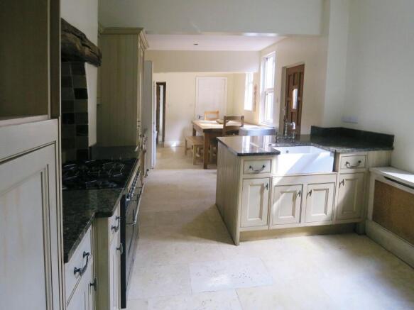 Bright and inviting kitchen with ample cabinetr...