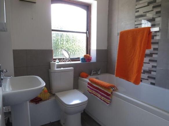Bright and well-maintained bathroom featuring a...