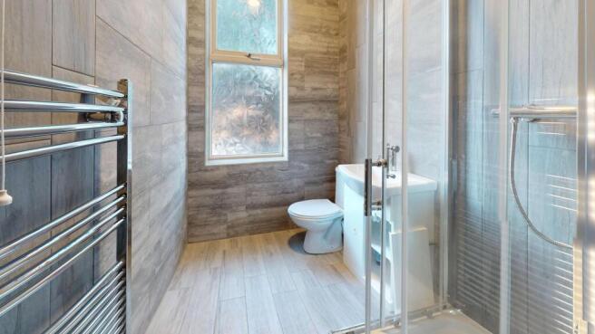 Bright and modern bathroom featuring a large wi...
