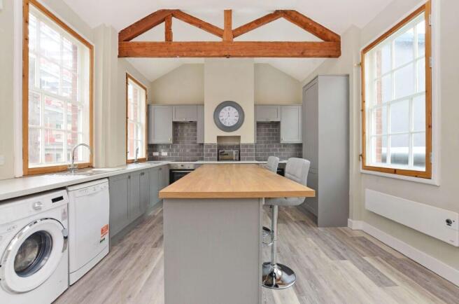 Bright and spacious kitchen featuring large win...