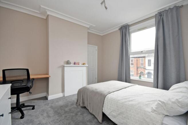 Bright and welcoming bedroom with a large windo...