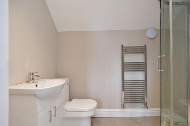 A modern bathroom featuring a white sink with a...