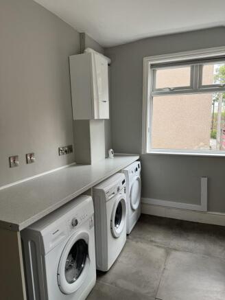 A clean and well-organized laundry area with mo...