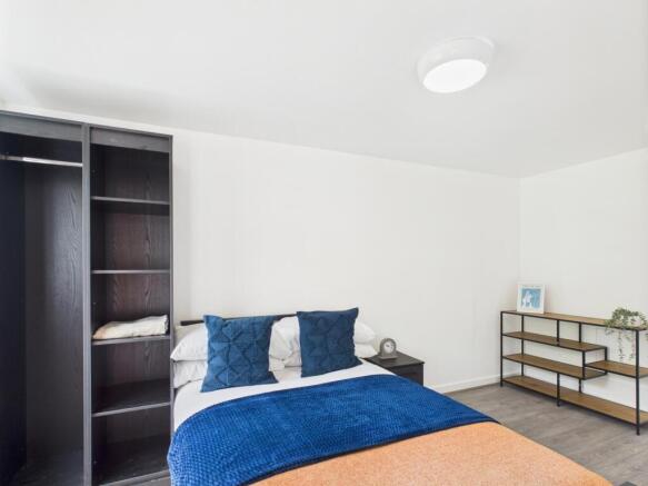 Bright, neatly presented bedroom with a comfort...