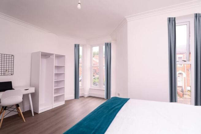 A bright and spacious double bedroom featuring ...