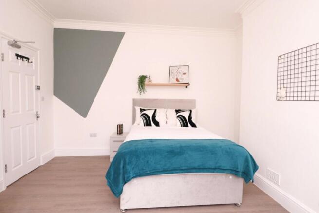 A stylish and bright double bedroom featuring m...