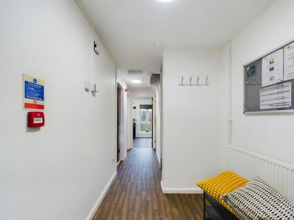 A tidy and bright hallway with modern decor, pe...