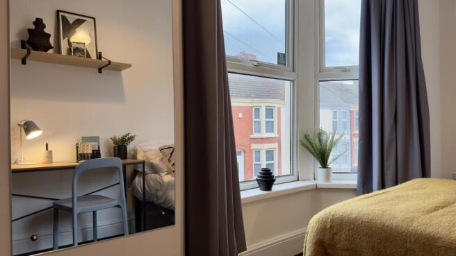 A bright and inviting double bedroom featuring ...