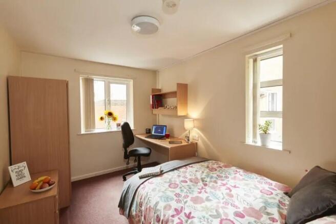 A bright and inviting double bedroom with ample...