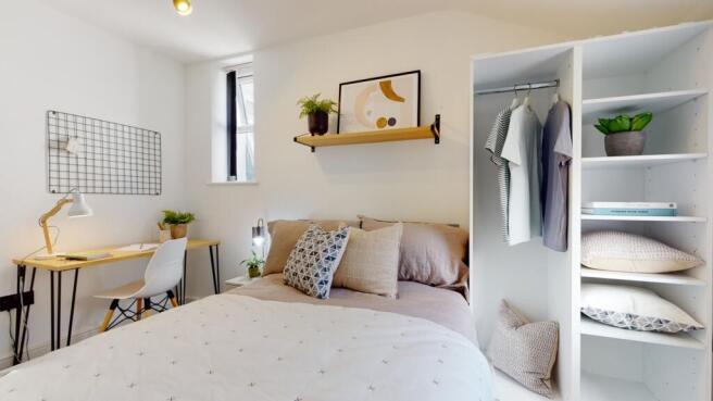 A stylish and well-lit double bedroom featuring...