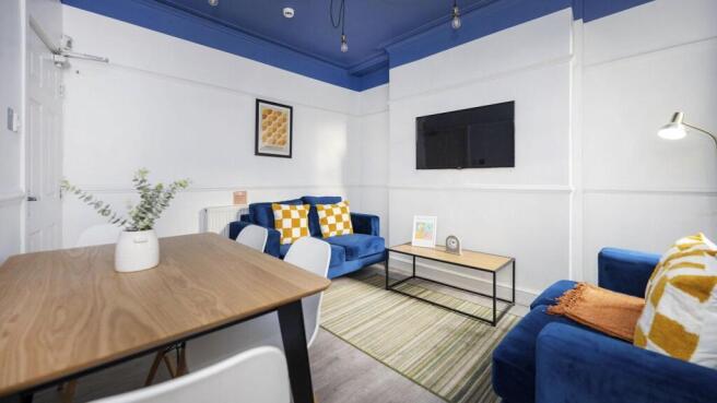 A spacious and inviting modern living room, per...