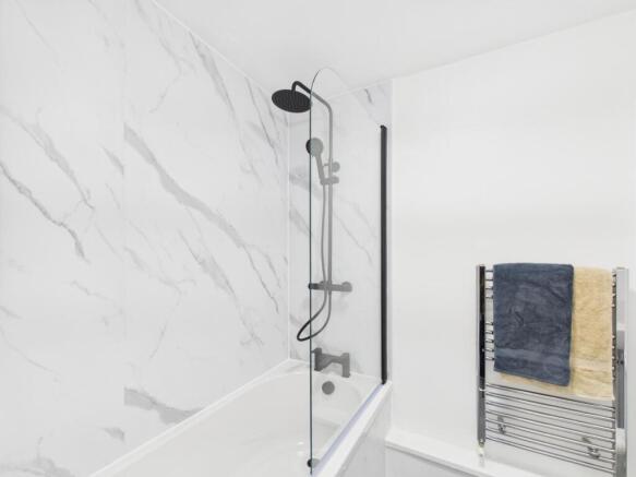 Bright, modern bathroom featuring a sleek showe...
