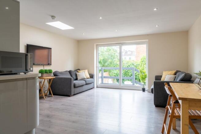 Bright modern living room with large sliding do...