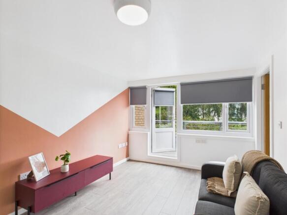 Bright, modern living room with a large window ...