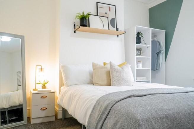 A bright and inviting double bedroom featuring ...