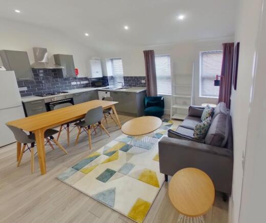 A bright and spacious living room featuring mod...